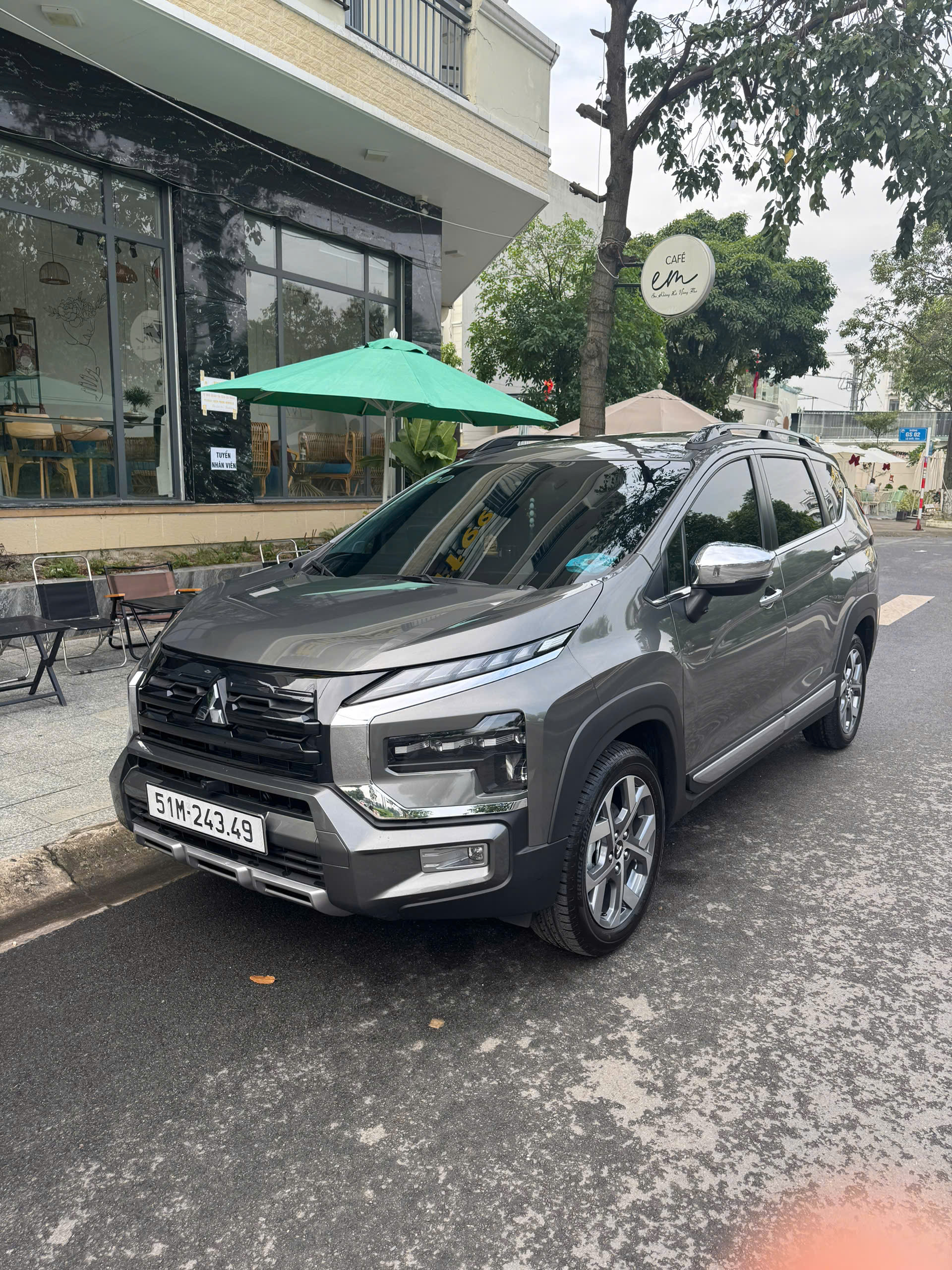 Grey Mitsubishi Xpander parked outside a building