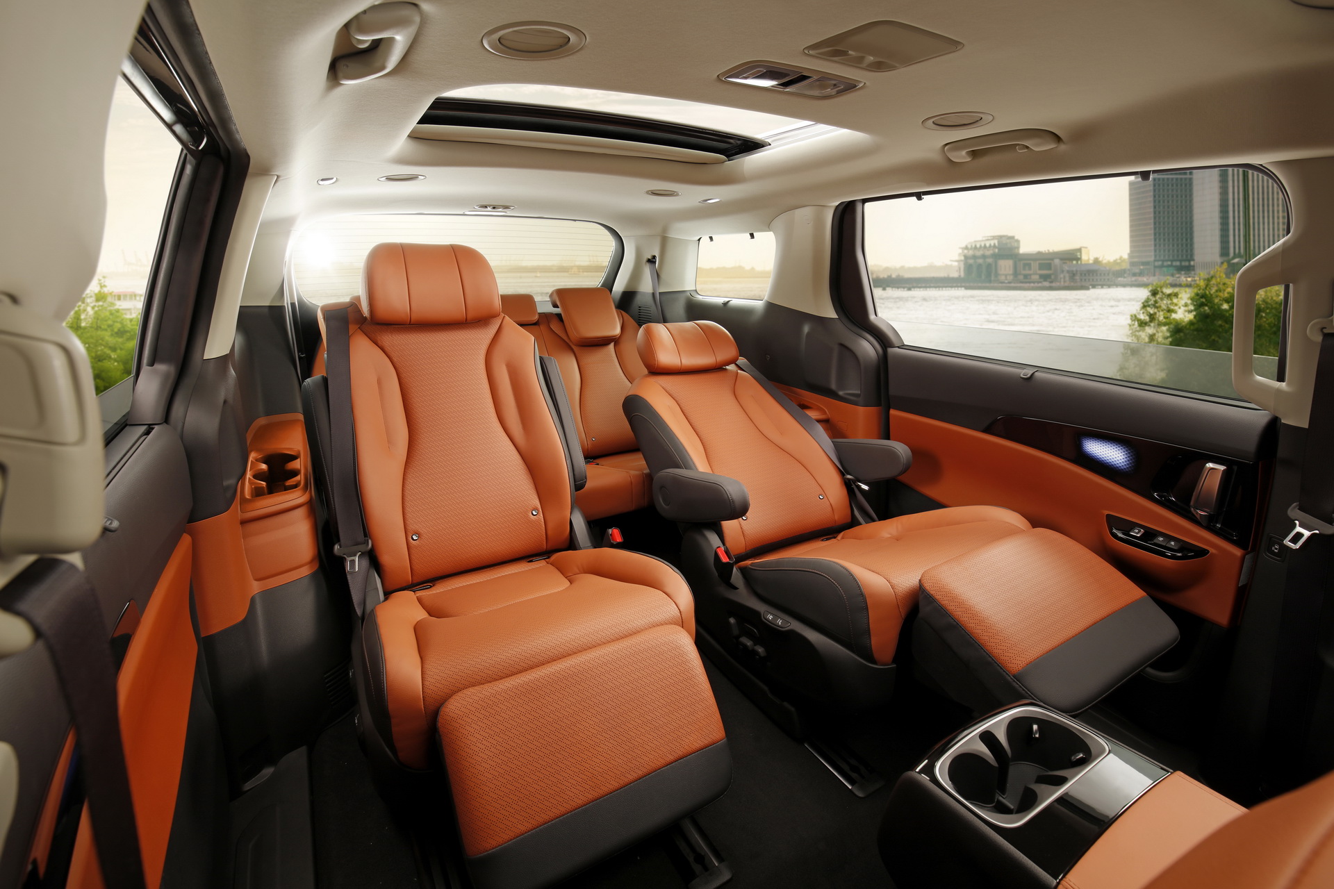 Carnival cabin with orange individual seats, a visible sunroof and one leg rest extended